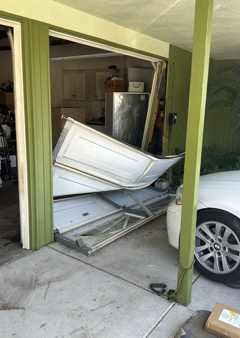 Garage door panels damaged by a vehicle impact
