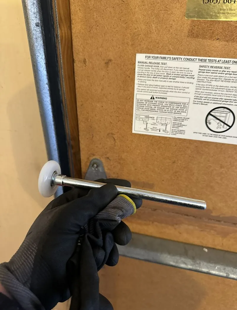 Technician checking a garage door roller